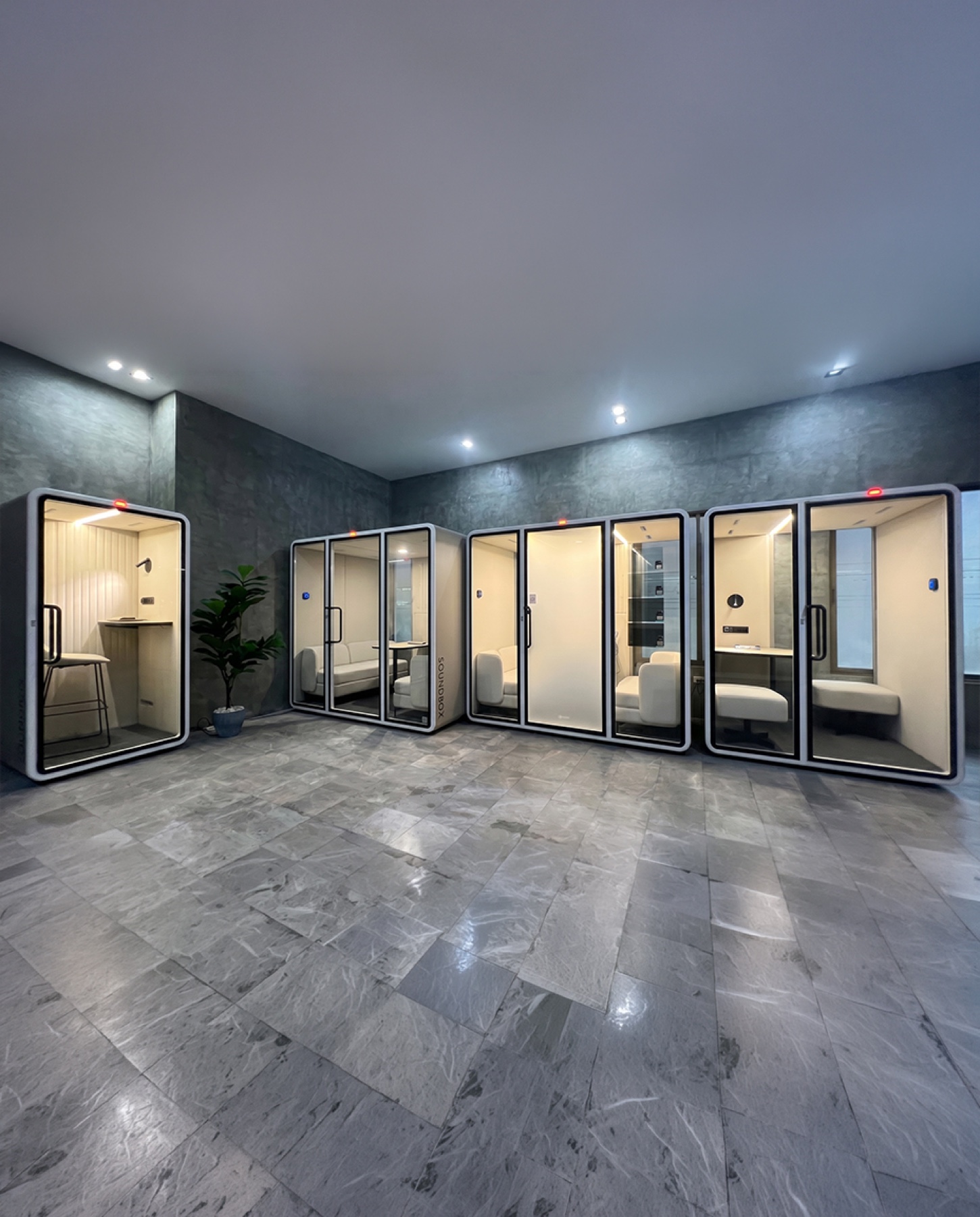 ZOUND pods lined up in the stone-floored showroom